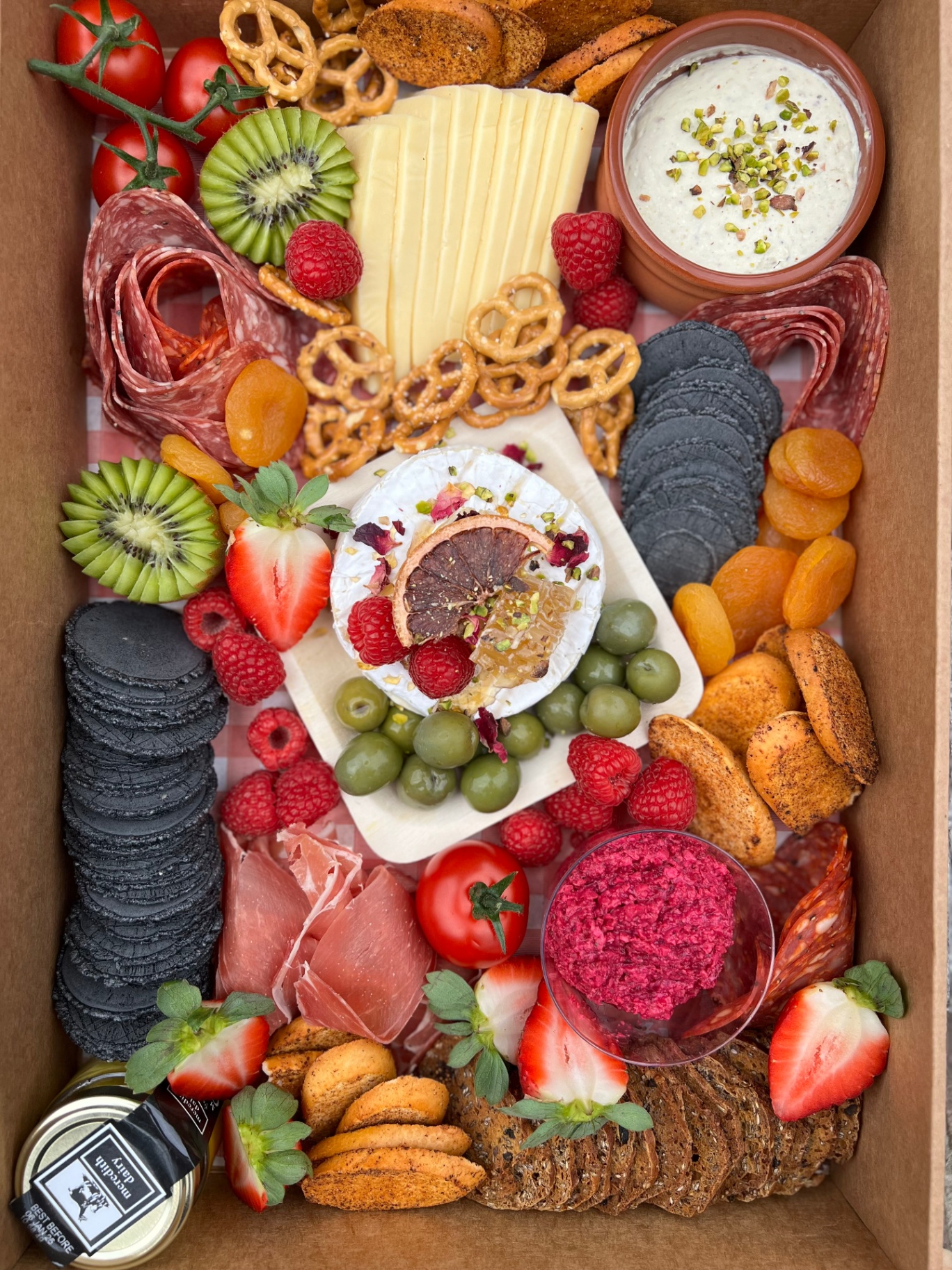 Grazing box with brie, honeycomb, salami and olives
