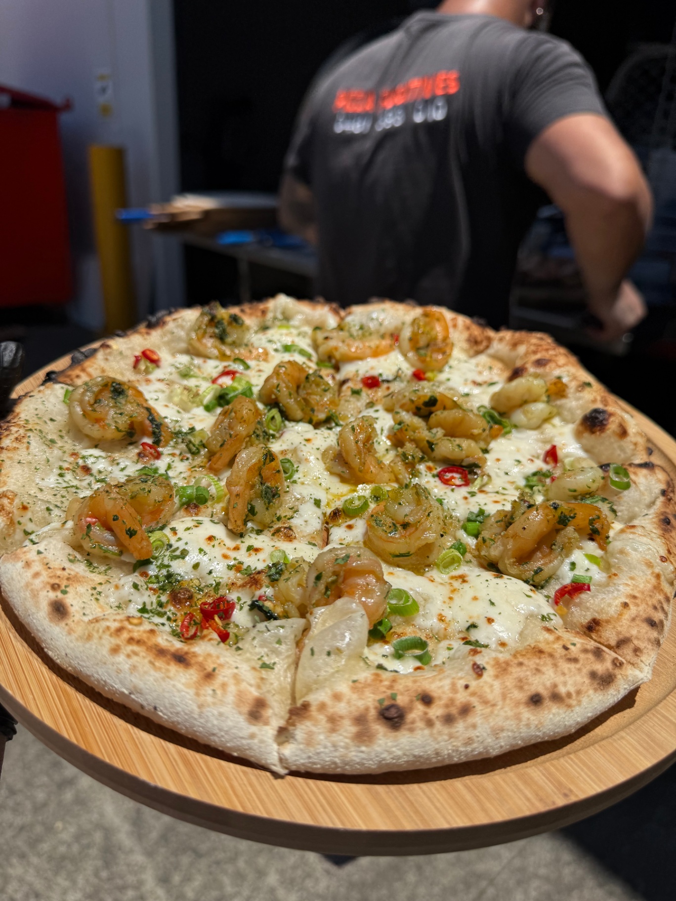 Prawn pizza with chilli and herbs fresh from the oven