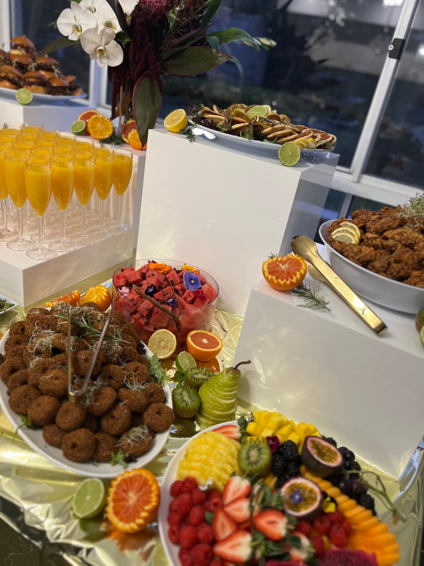 Mimosa flutes, fried chicken and fresh fruit platters