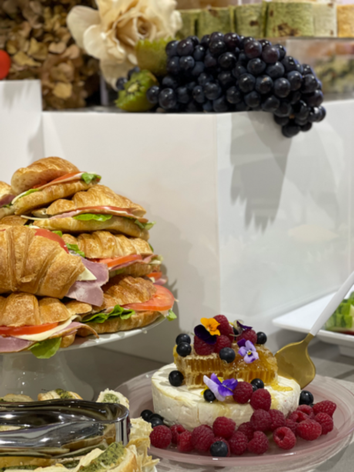 Brunch banquet spread with croissants, cheese and fruit