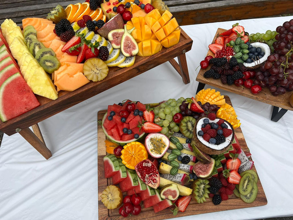 Overhead grazing table spread with fruit, charcuterie and styling
