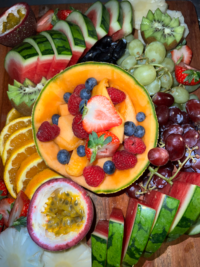 Fruit board close-up with melon and berries